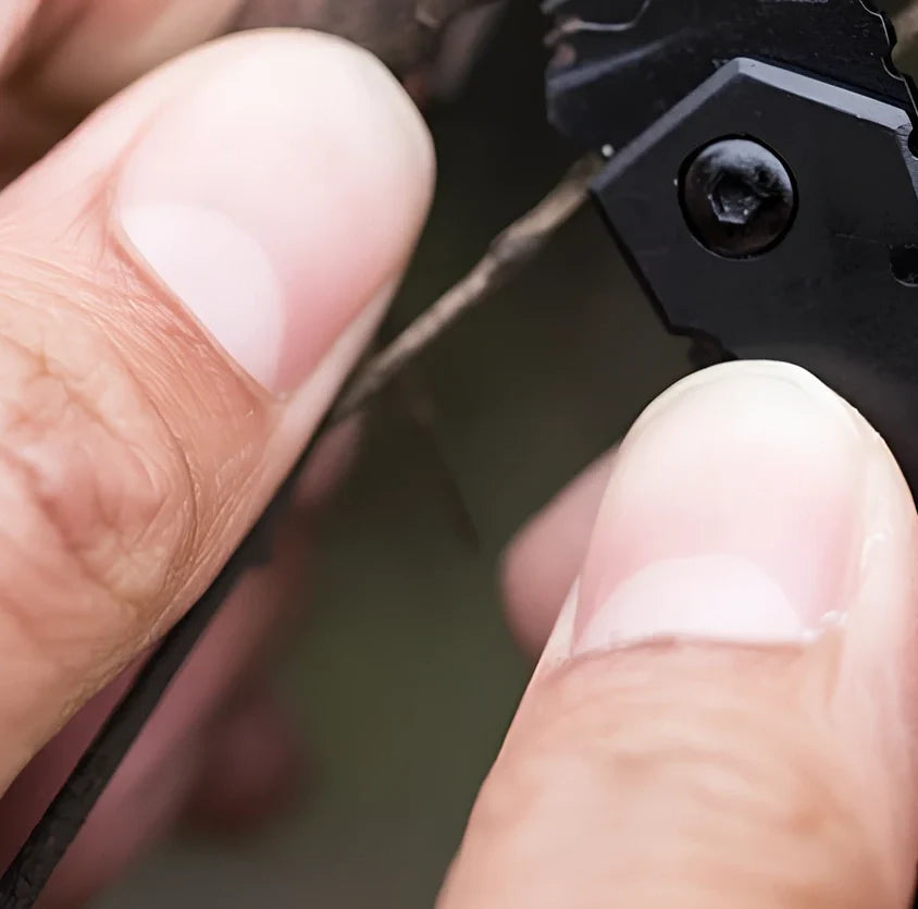 Black pocket folding knife with serrated blade, shown open at 85mm length and closed at 5mm thickness