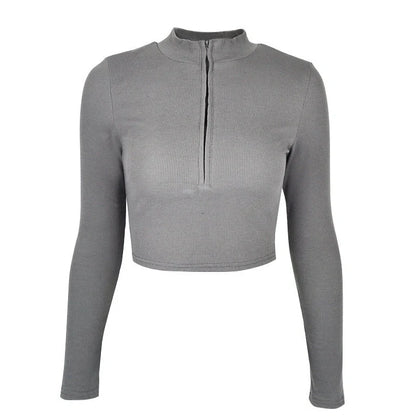 Women's black zip-front crop top with slim fit and long sleeves on hanger