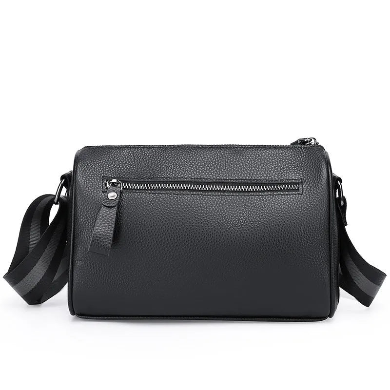 Black genuine leather one-shoulder crossbody bag with large main compartment and polyester lining.