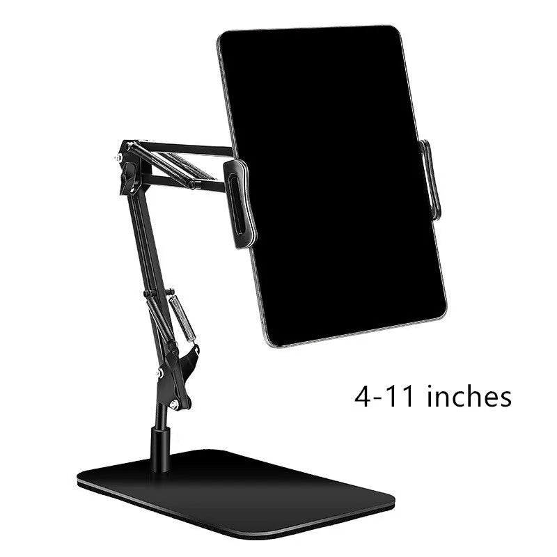 Black metal adjustable phone and tablet stand with a heavy round base on a wooden desk