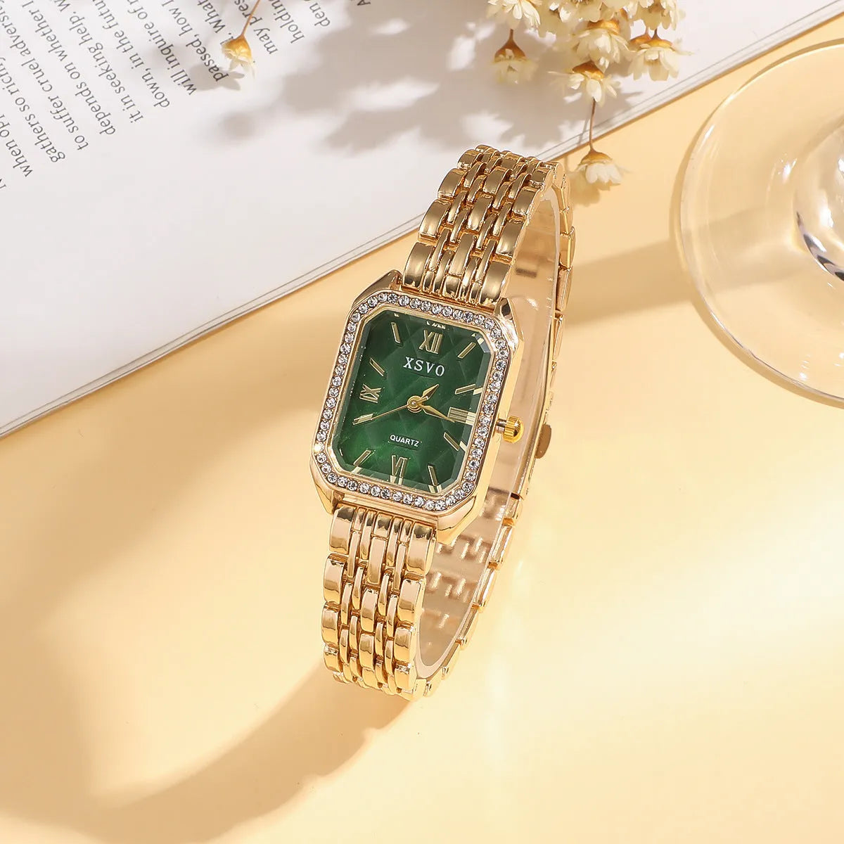 Gold green square women's watch with four matching butterfly bracelets on display