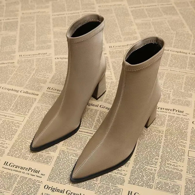Women's khaki stretch suedette pointed toe ankle boots with a mid block heel on a white background.