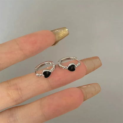 Black love heart earrings for women with alloy construction and ear clip design