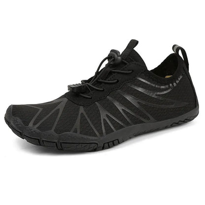 Men's and women's low-top breathable sports running shoes with a natural rubber sole on a hard ground surface.
