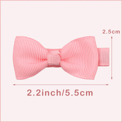 Assortment of pastel-coloured baby hair clips and bows with no-slip grips on a white background.