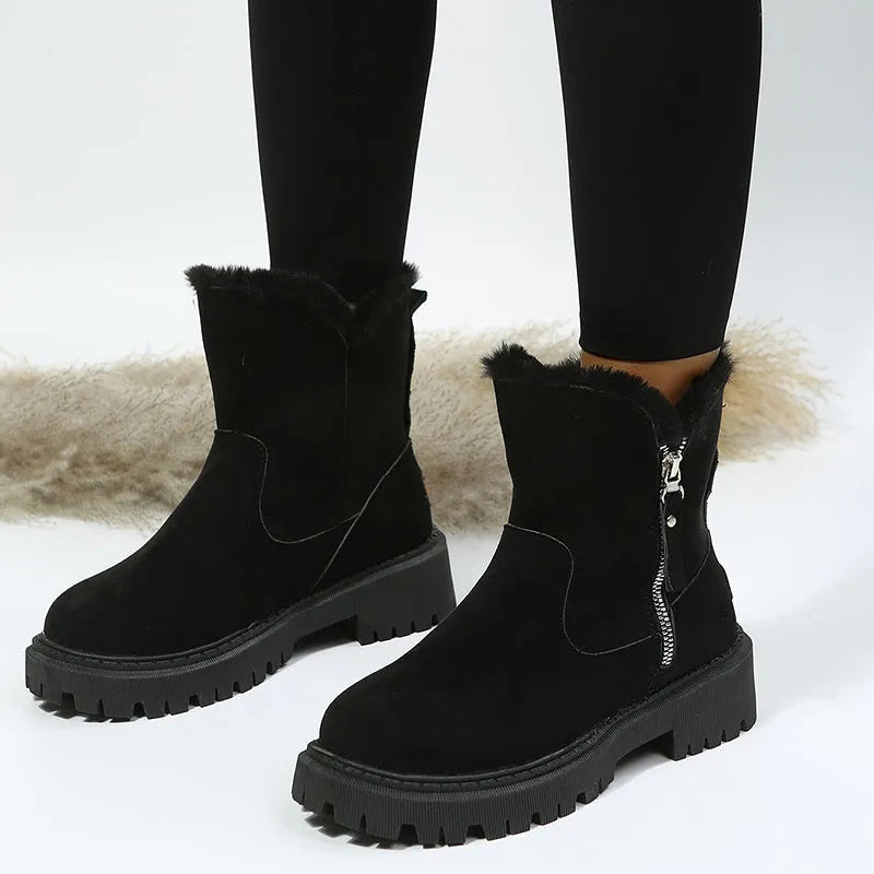 Women's black faux suede high-top snow boots with a side zipper and fur-lined collar.