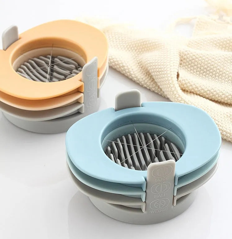 Three-function manual egg cutter in blue with stackable design for kitchen use