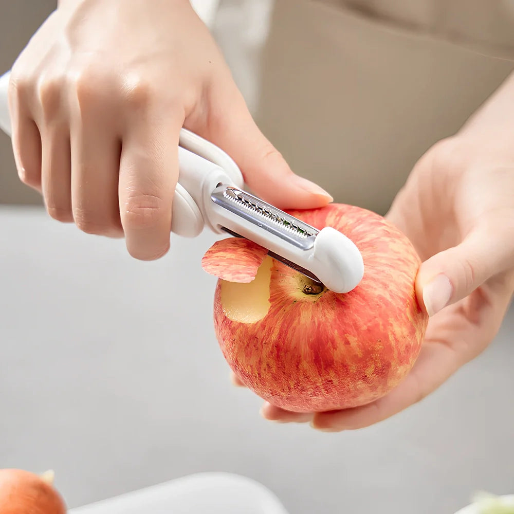 White 3-in-1 rotary paring knife with rotating blades and integrated sharpener for kitchen use
