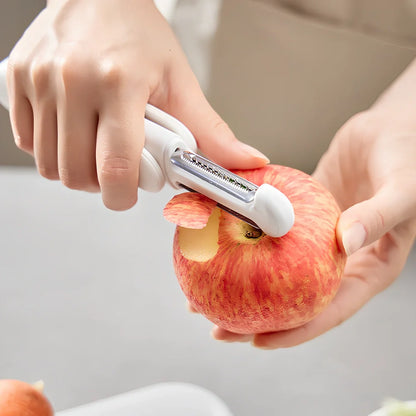 White 3-in-1 rotary paring knife with rotating blades and integrated sharpener for kitchen use