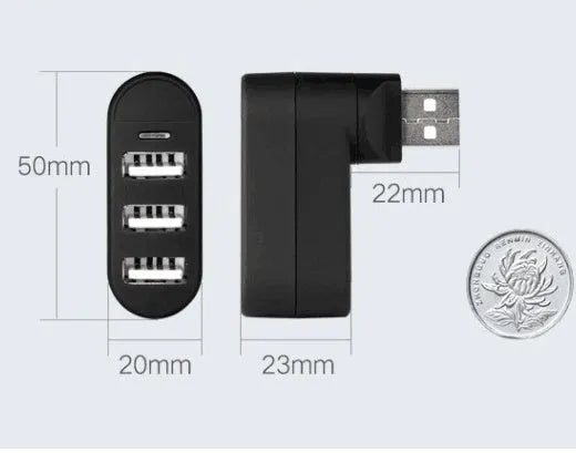 Black and white USB 2.0 hub splitter with spin colour casing on a desk next to a laptop.