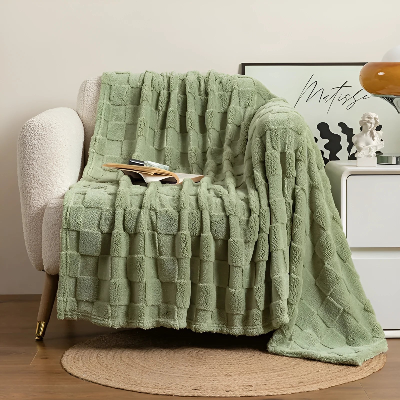 Geometric pattern polyester blanket in dark grey colour draped over sofa