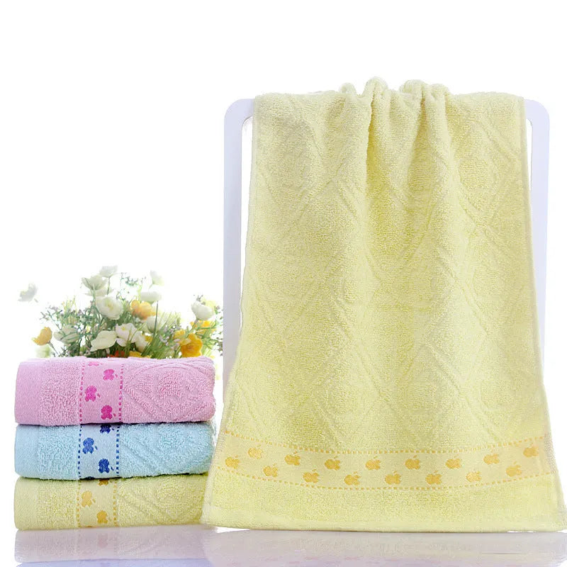 Cotton face towel in blue, pink and yellow colours with heart patterns, dimensions 73x33cm