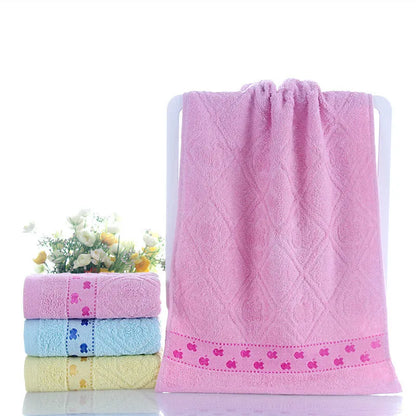 Cotton face towel in blue, pink and yellow colours with heart patterns, dimensions 73x33cm