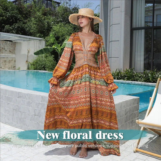Elegant floral print dress with long sleeves and empire waistline in vibrant orange color