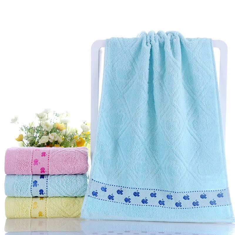 Cotton face towel in blue, pink and yellow colours with heart patterns, dimensions 73x33cm