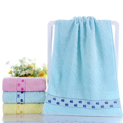 Cotton face towel in blue, pink and yellow colours with heart patterns, dimensions 73x33cm