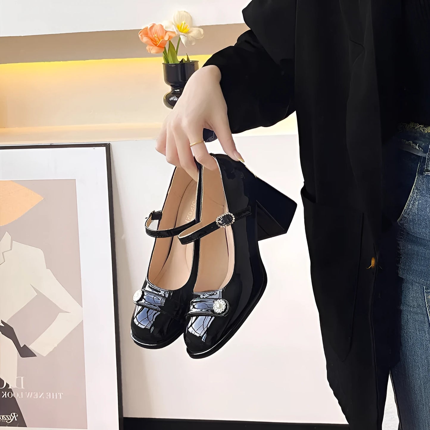 Black patent leather women's high heels with a chunky heel, round toe, and buckle fastening.