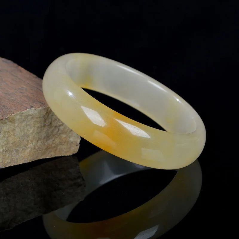 A polished natural jade bracelet in a traditional Chinese style, shown with a size guide for 54mm to 62mm.