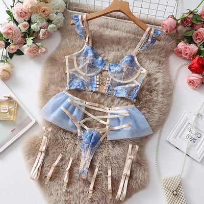 Light blue embroidered lace push-up bra and matching underwear set with mesh panels on a mannequin.