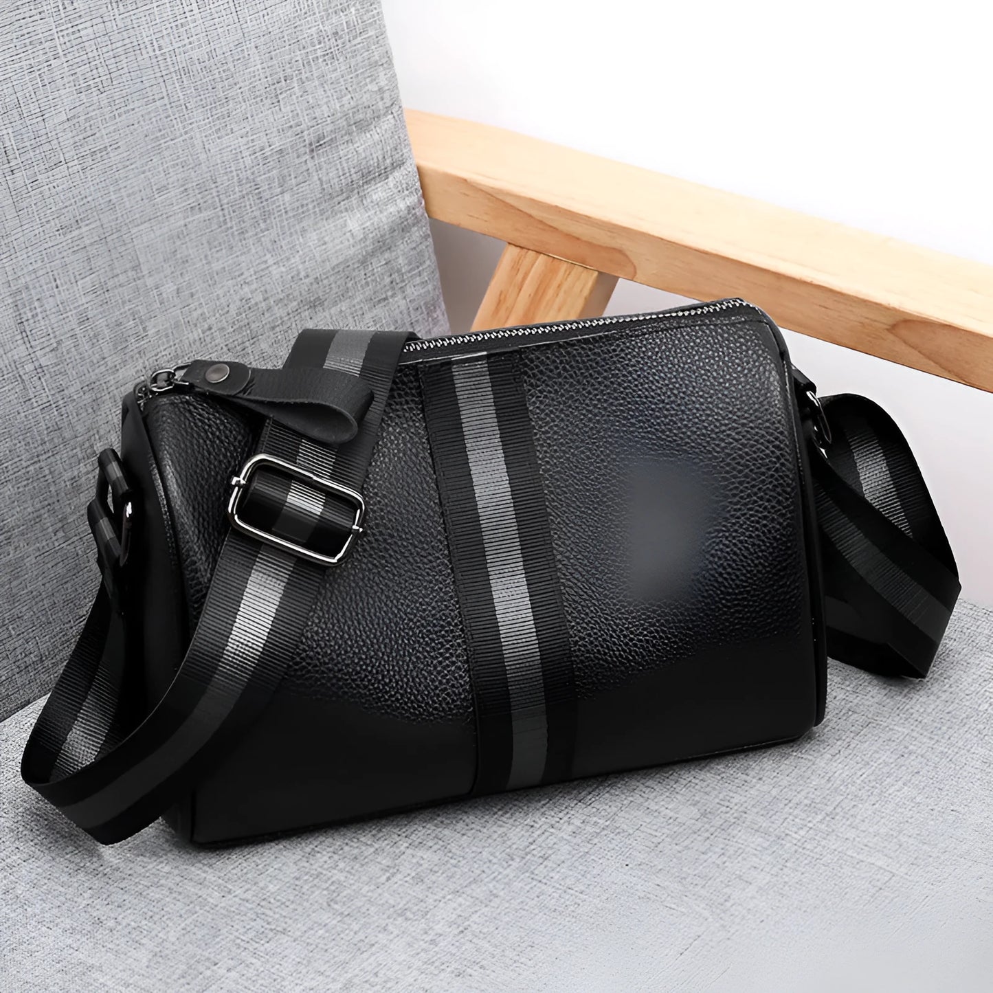 Black genuine leather one-shoulder crossbody bag with large main compartment and polyester lining.