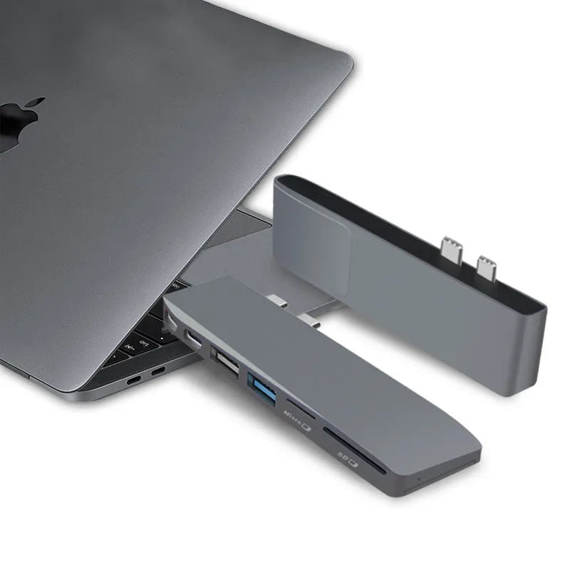Silver 8-in-1 USB-C card reader hub for MacBook Pro with multiple ports including USB and SD slots.