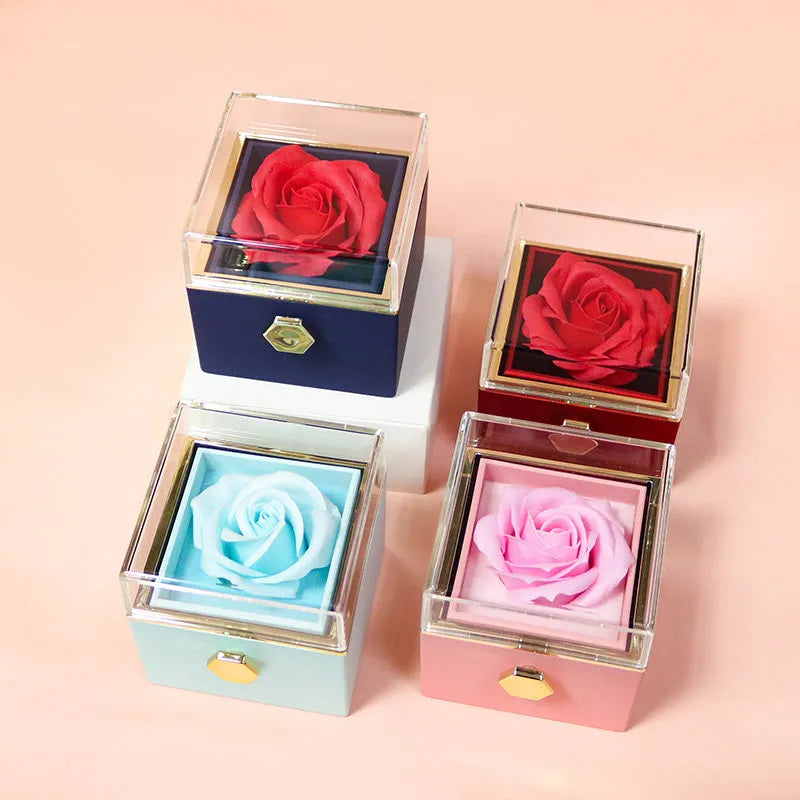 Rotating rose jewellery gift box with a preserved red rose under a clear acrylic dome, showing the interior rotating drawer.