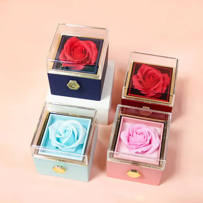 Rotating rose jewellery gift box with a preserved red rose under a clear acrylic dome, showing the interior rotating drawer.