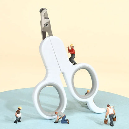 Grey and pink pet nail clippers with curved tips and a rubber-coated ergonomic handle on a table.