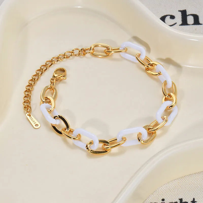 Women's stainless steel bracelet with double-layered heart design and resin accents, showing adjustable clasp and electroplated finish