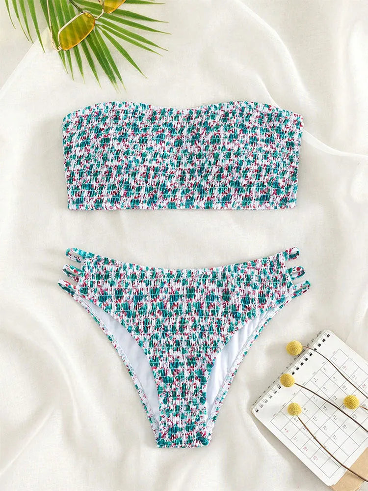 Women's strapless floral swimsuit with high-waist briefs and split back in green flower pattern.