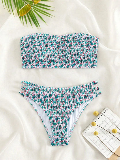 Women's strapless floral swimsuit with high-waist briefs and split back in green flower pattern.
