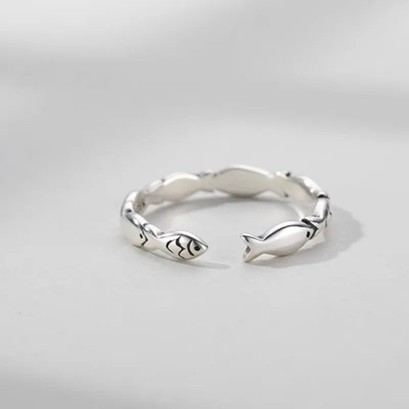 Women's adjustable sterling silver fish ring with detailed carp design on silver band