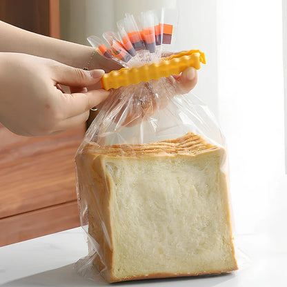 12-pack of white plastic food sealing clips, some with refrigerator stickers, for kitchen bag storage