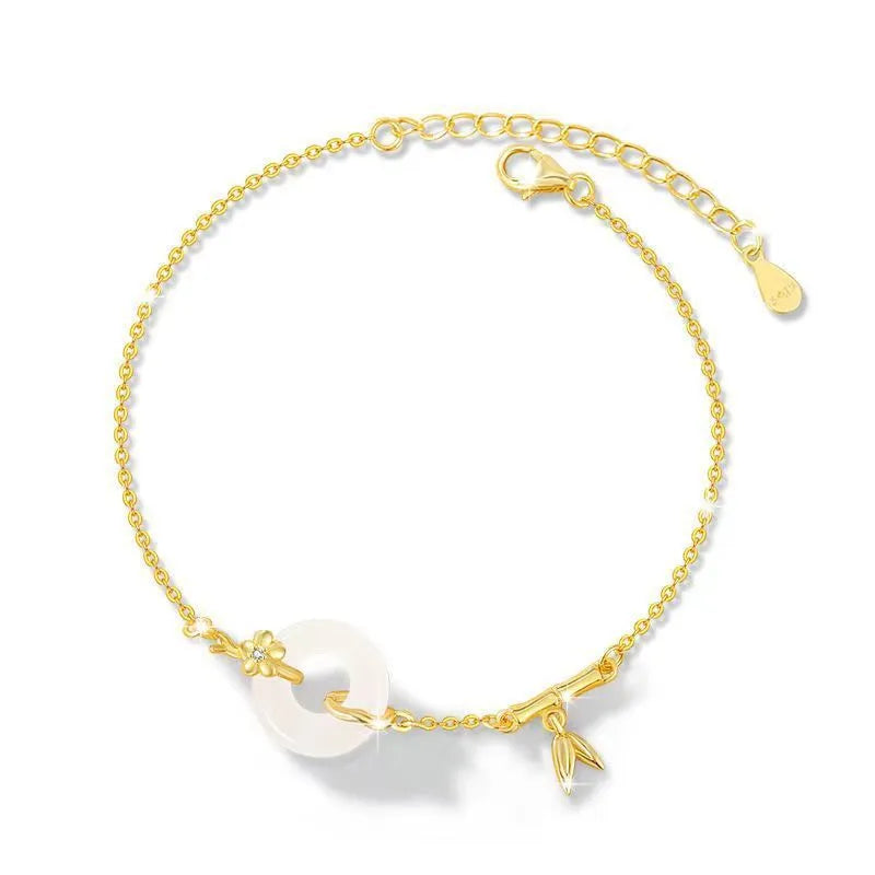 Women's silver and gold electroplated bracelet with peace buckle charm and white chalcedony stone.