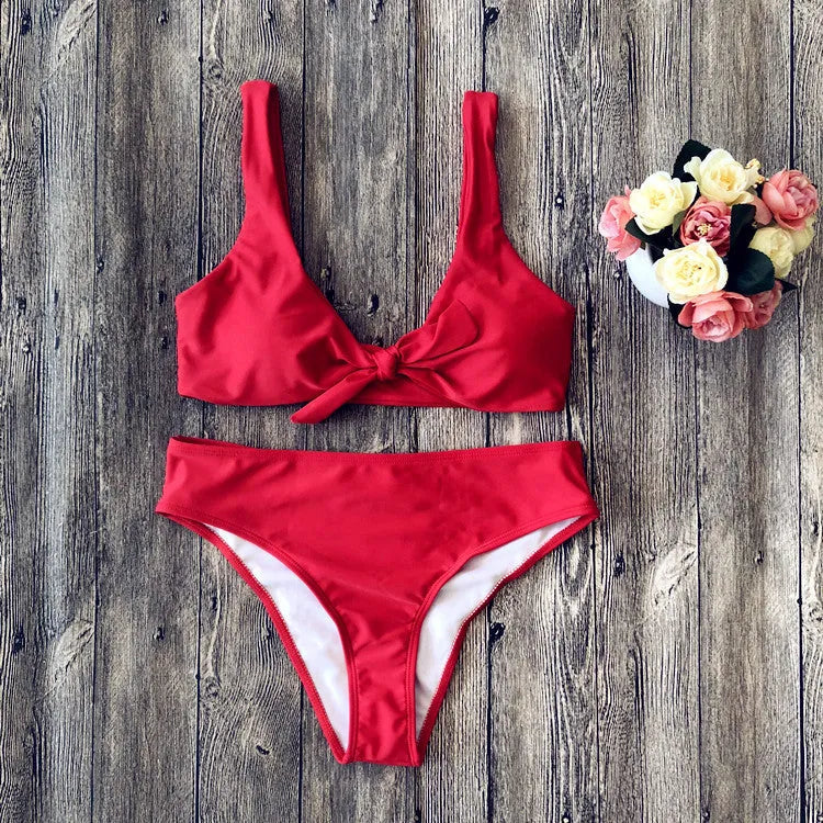Women's solid colour bikini set with sleeveless top and briefs on a neutral background