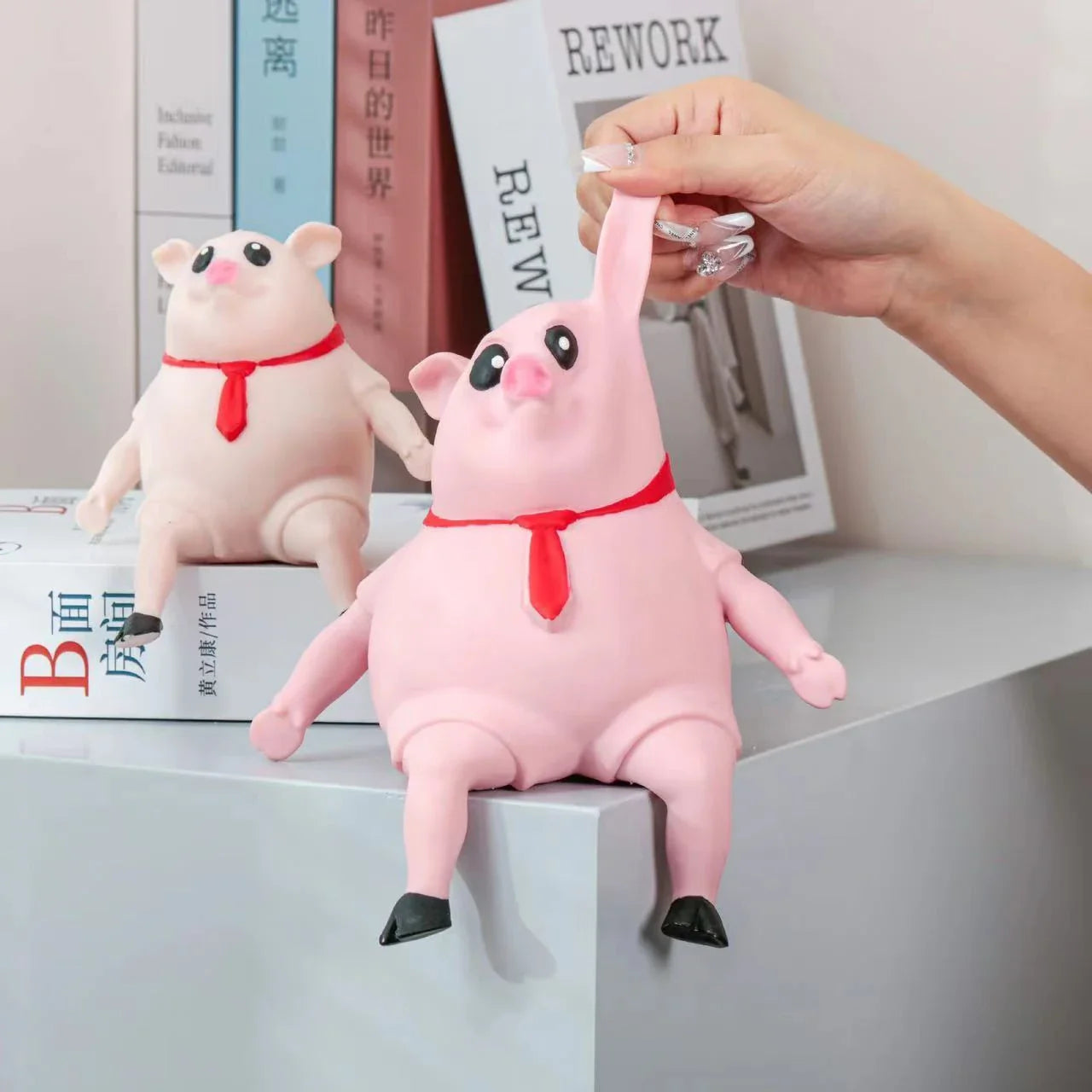 Adorable piggy-shaped stress relief toy made of eco-friendly rubber with a charming red scarf design