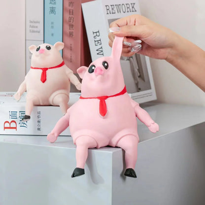 Adorable piggy-shaped stress relief toy made of eco-friendly rubber with a charming red scarf design