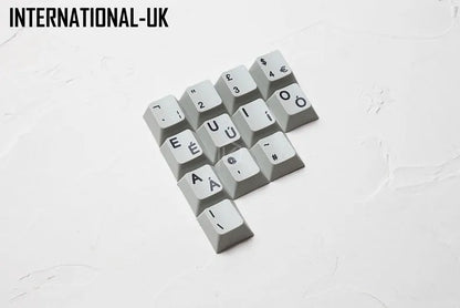 Wired keyboard with international symbol keycaps for ten European language layouts showing USB and PS/2 connections