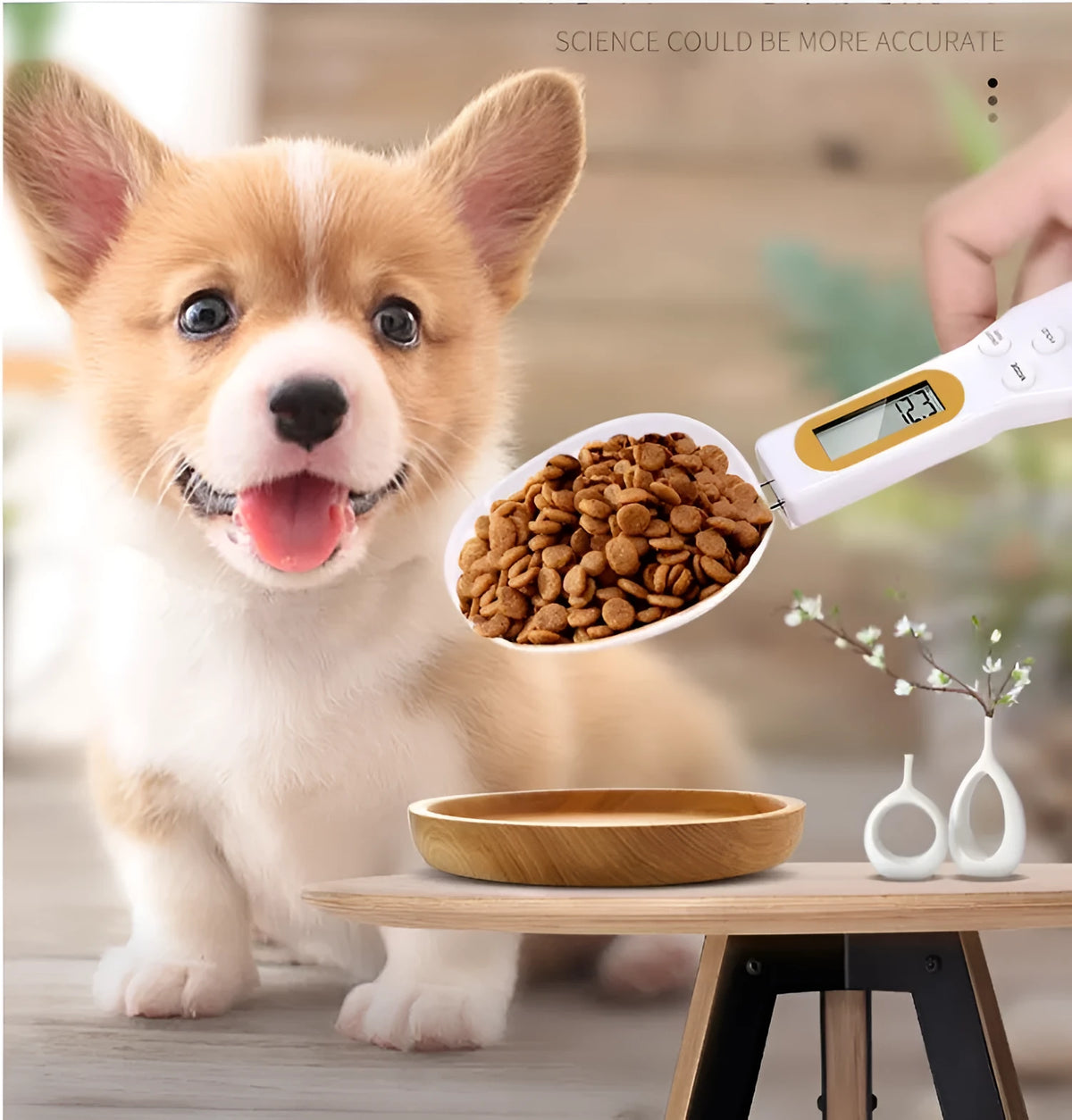 White electronic pet feeding weighing spoon with digital display and removable metal shovel head on a table.
