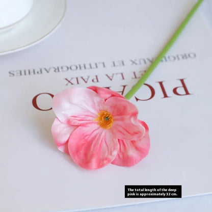 Pack of 15 mini artificial poppy flowers in assorted colours including purple, pink, yellow and red.