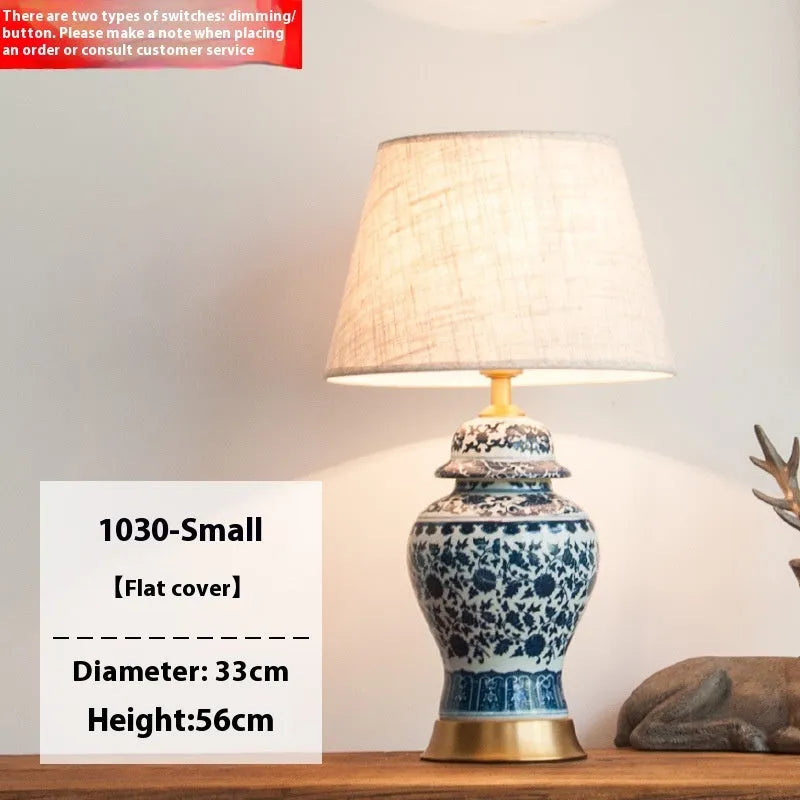 Chinese blue and white porcelain table lamp with cloth shade on bedside table