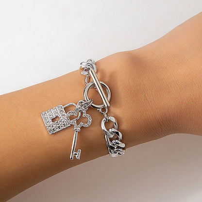 Elegant chain necklace and bracelet set with shiny lock and key pendant, fashionable ladies accessories