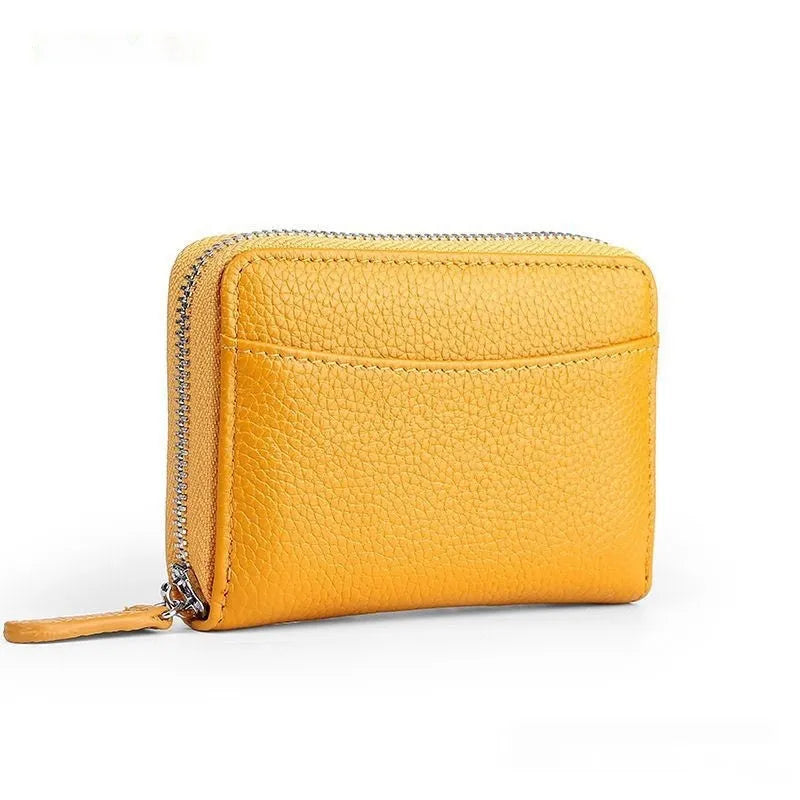 Genuine leather zipper coin purse in a solid colour showing sewing line detail.