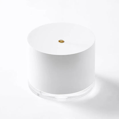 White portable ultrasonic humidifier with LED light and USB charging port on a wooden surface.