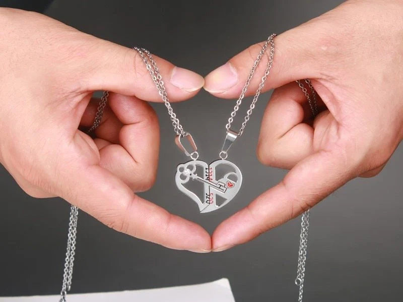 Captivating couples' love necklace set in gold, black, and silver colours with delicate chain and symbolic pendant design