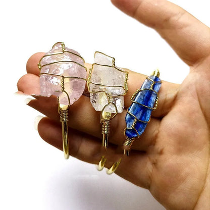 Natural gold winding crystal rough stone bracelet with unshaped geometric design on a wrist.