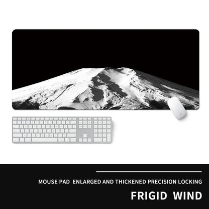 Oversized rectangular mouse pad with a printed design on a desk, next to a keyboard and mouse.