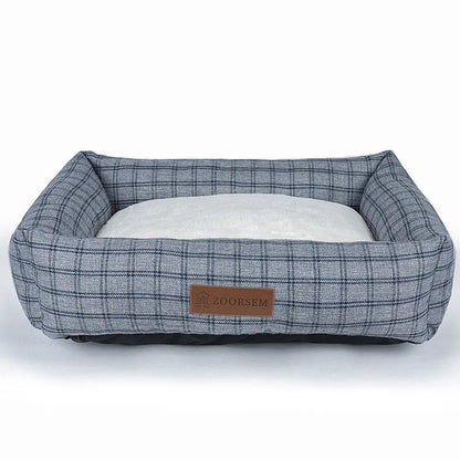 Grey linen-look square dog bed for medium-sized dogs on a wooden floor