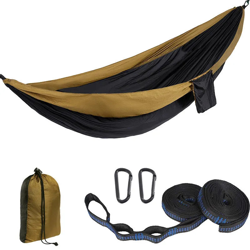 Parachute cloth double camping hammock in chosen colour, with black buckles and round ropes on a tree.