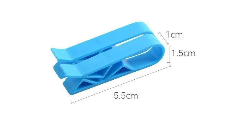 A white polypropylene plastic clip for holding a rubbish bag onto the rim of a bin.